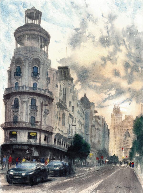 “An Afternoon on Gran Via” is an original watercolor painting of Gran Via street in Madrid, capturing the city’s elegance as daylight fades into evening. The artwork portrays the sweeping curve of the boulevard, framed by graceful architecture and bathed in the warm glow of the setting sun. The soft light and gentle shadows create a sense of calm and movement, reflecting the timeless rhythm of Madrid.
